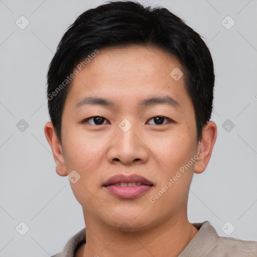 Joyful asian young-adult male with short  black hair and brown eyes