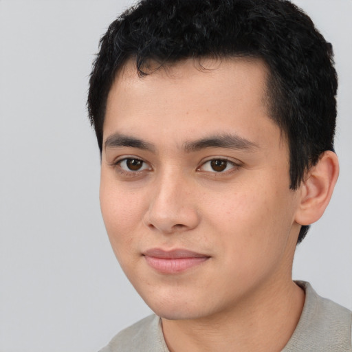 Joyful asian young-adult male with short  black hair and brown eyes