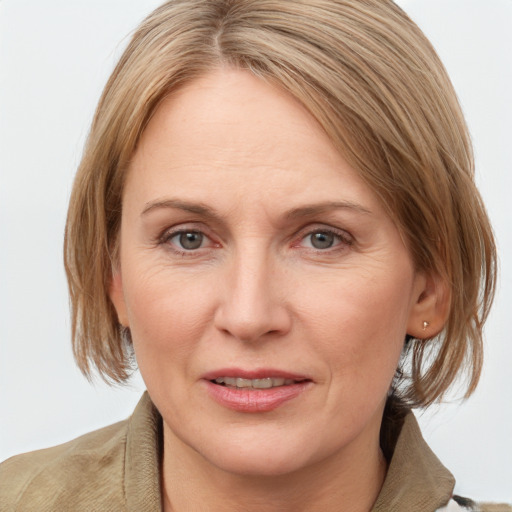 Joyful white adult female with medium  brown hair and grey eyes