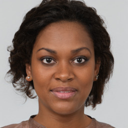 Joyful black young-adult female with medium  brown hair and brown eyes