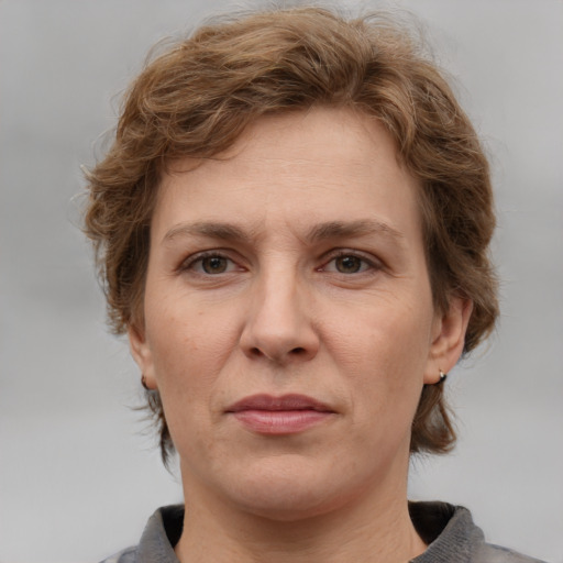 Joyful white adult female with medium  brown hair and grey eyes