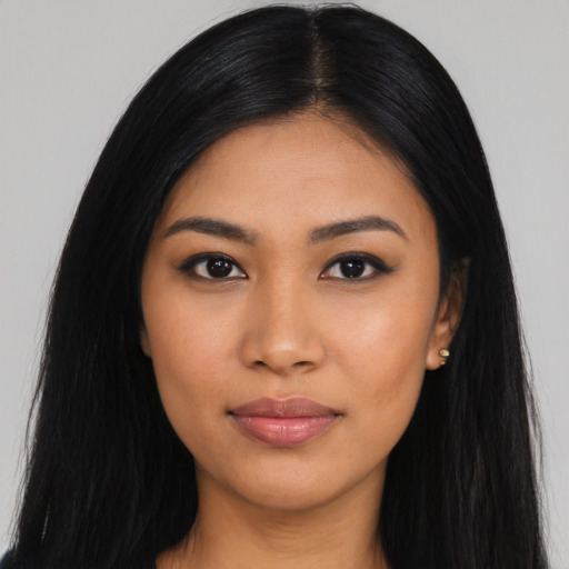 Joyful latino young-adult female with long  black hair and brown eyes