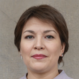 Joyful white adult female with medium  brown hair and brown eyes