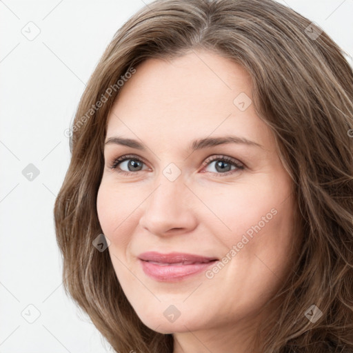 Joyful white young-adult female with long  brown hair and green eyes