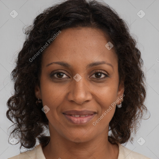 Joyful black adult female with medium  brown hair and brown eyes