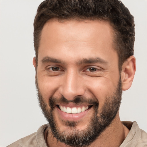 Joyful white young-adult male with short  brown hair and brown eyes