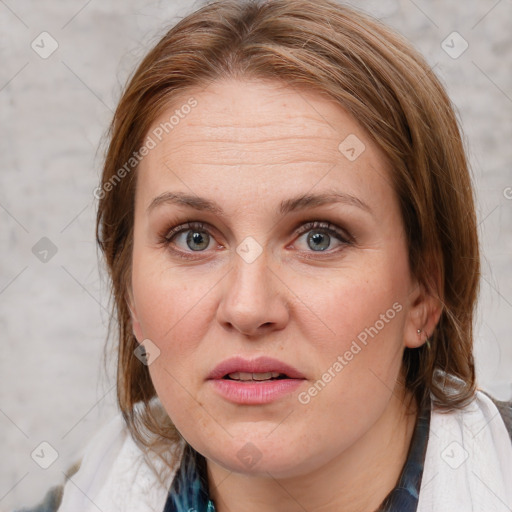 Joyful white adult female with medium  brown hair and blue eyes