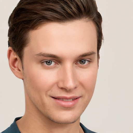 Joyful white young-adult male with short  brown hair and grey eyes