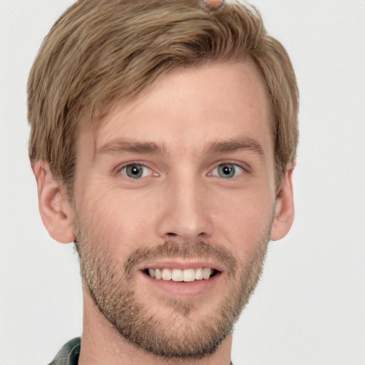 Joyful white young-adult male with short  brown hair and grey eyes