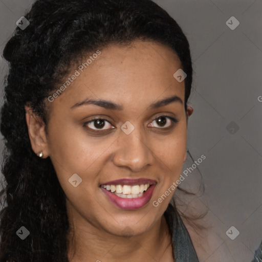 Joyful black young-adult female with long  brown hair and brown eyes