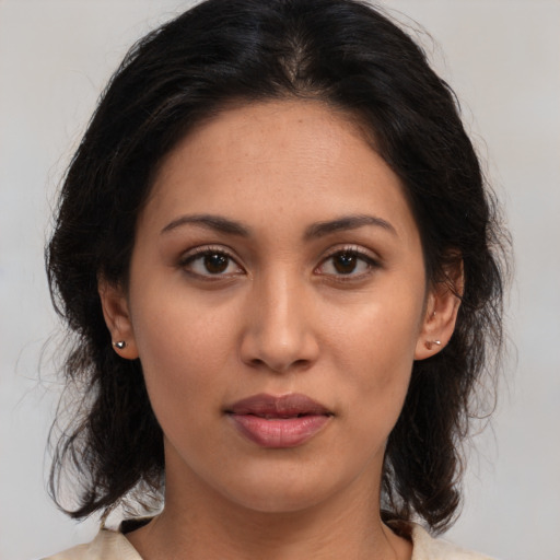 Joyful latino young-adult female with medium  brown hair and brown eyes