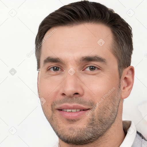 Joyful white young-adult male with short  brown hair and brown eyes