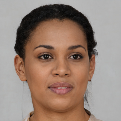 Joyful black young-adult female with short  brown hair and brown eyes