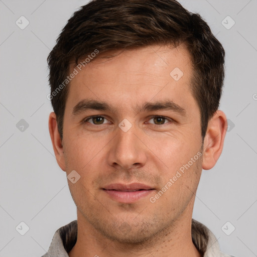 Joyful white young-adult male with short  brown hair and grey eyes