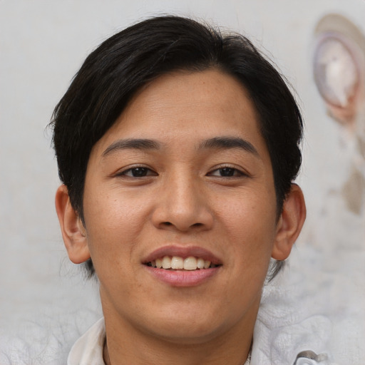 Joyful asian young-adult female with short  brown hair and brown eyes