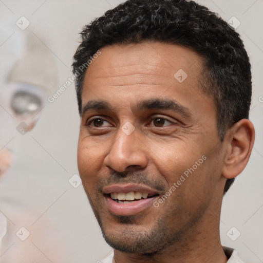 Joyful white adult male with short  black hair and brown eyes