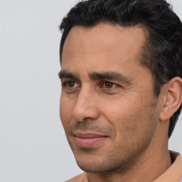 Joyful white adult male with short  black hair and brown eyes