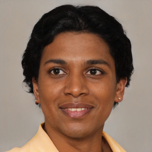 Joyful latino young-adult female with short  black hair and brown eyes