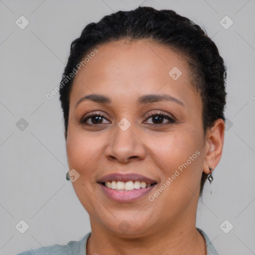 Joyful black young-adult female with short  brown hair and brown eyes