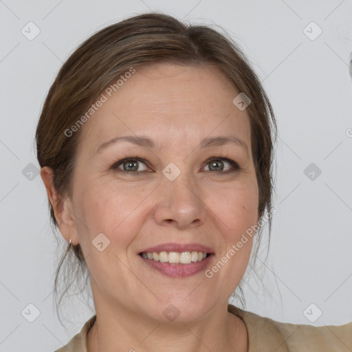 Joyful white adult female with medium  brown hair and grey eyes