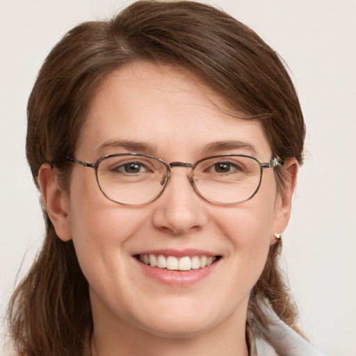 Joyful white adult female with medium  brown hair and blue eyes