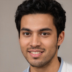 Joyful white young-adult male with short  black hair and brown eyes