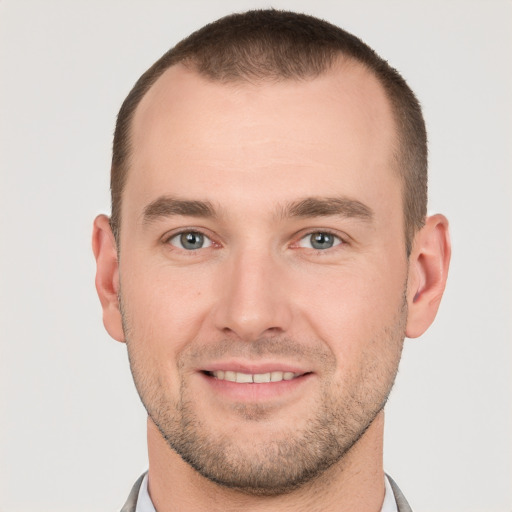 Joyful white young-adult male with short  brown hair and grey eyes