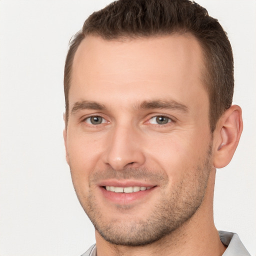 Joyful white young-adult male with short  brown hair and brown eyes