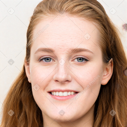 Joyful white young-adult female with long  brown hair and blue eyes