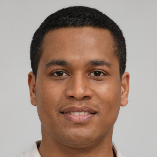 Joyful latino young-adult male with short  brown hair and brown eyes