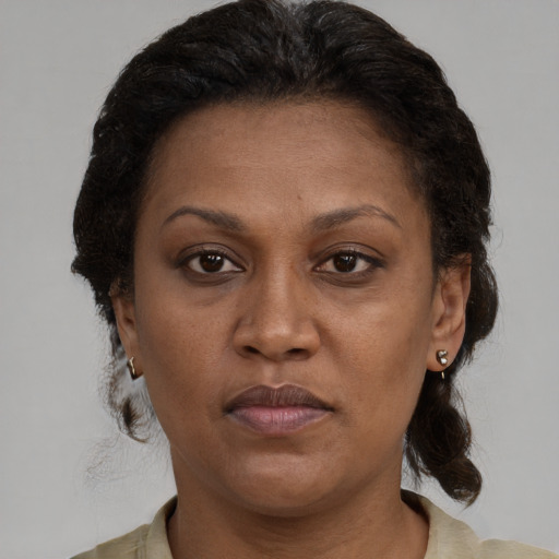 Joyful black adult female with short  brown hair and brown eyes