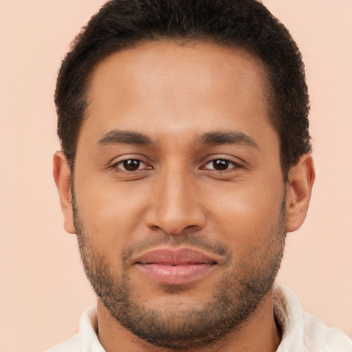 Joyful black young-adult male with short  brown hair and brown eyes