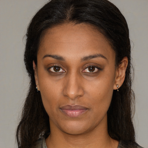 Neutral black young-adult female with long  brown hair and brown eyes