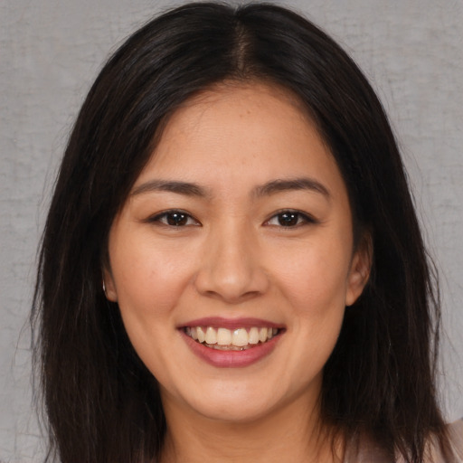 Joyful white young-adult female with long  brown hair and brown eyes