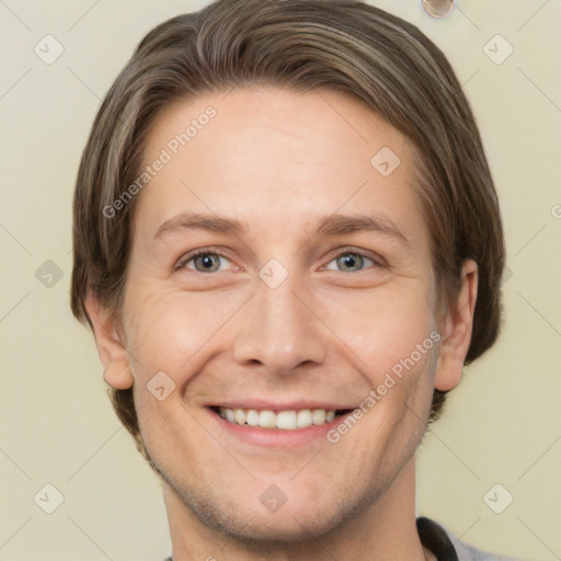 Joyful white young-adult male with short  brown hair and grey eyes