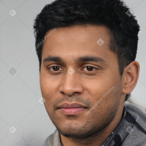 Joyful latino young-adult male with short  black hair and brown eyes