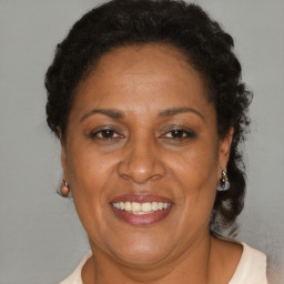 Joyful black adult female with short  brown hair and brown eyes