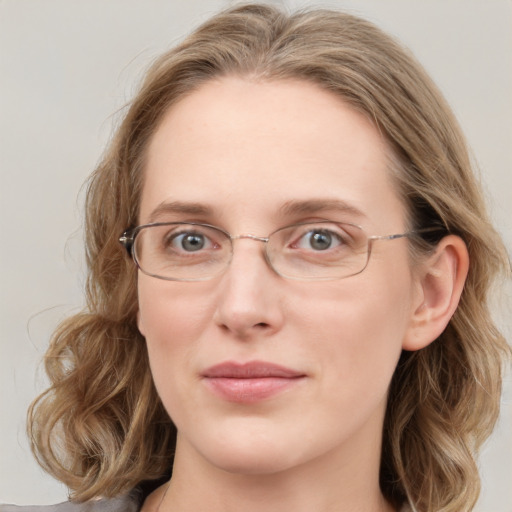 Joyful white young-adult female with long  brown hair and blue eyes