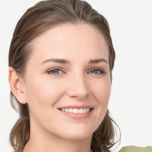 Joyful white young-adult female with medium  brown hair and grey eyes