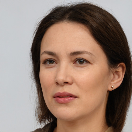 Joyful white adult female with medium  brown hair and brown eyes