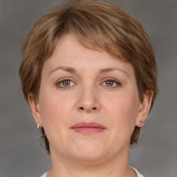 Joyful white adult female with medium  brown hair and grey eyes