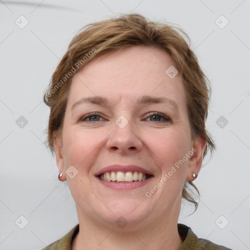 Joyful white adult female with medium  brown hair and grey eyes