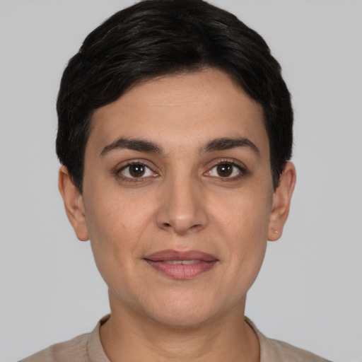Joyful white young-adult female with short  black hair and brown eyes