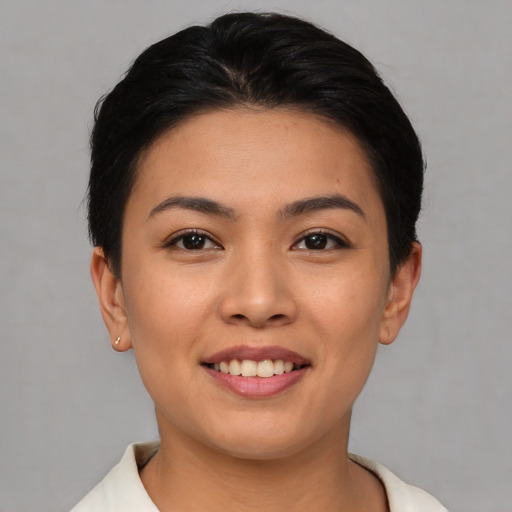 Joyful asian young-adult female with short  brown hair and brown eyes