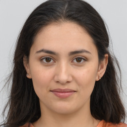 Joyful white young-adult female with long  brown hair and brown eyes