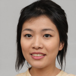 Joyful asian young-adult female with medium  brown hair and brown eyes