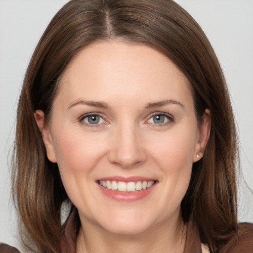 Joyful white young-adult female with medium  brown hair and grey eyes