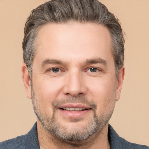 Joyful white adult male with short  brown hair and brown eyes