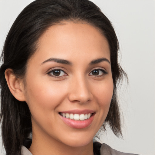 Joyful white young-adult female with long  brown hair and brown eyes