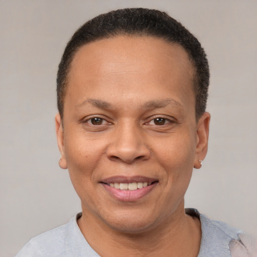 Joyful black adult female with short  brown hair and brown eyes